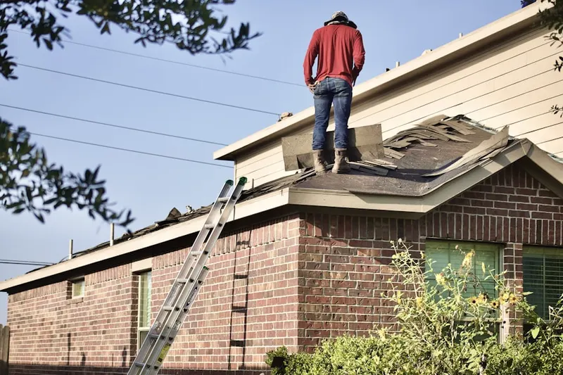 Professional roofer working on a residential roof in Morehead